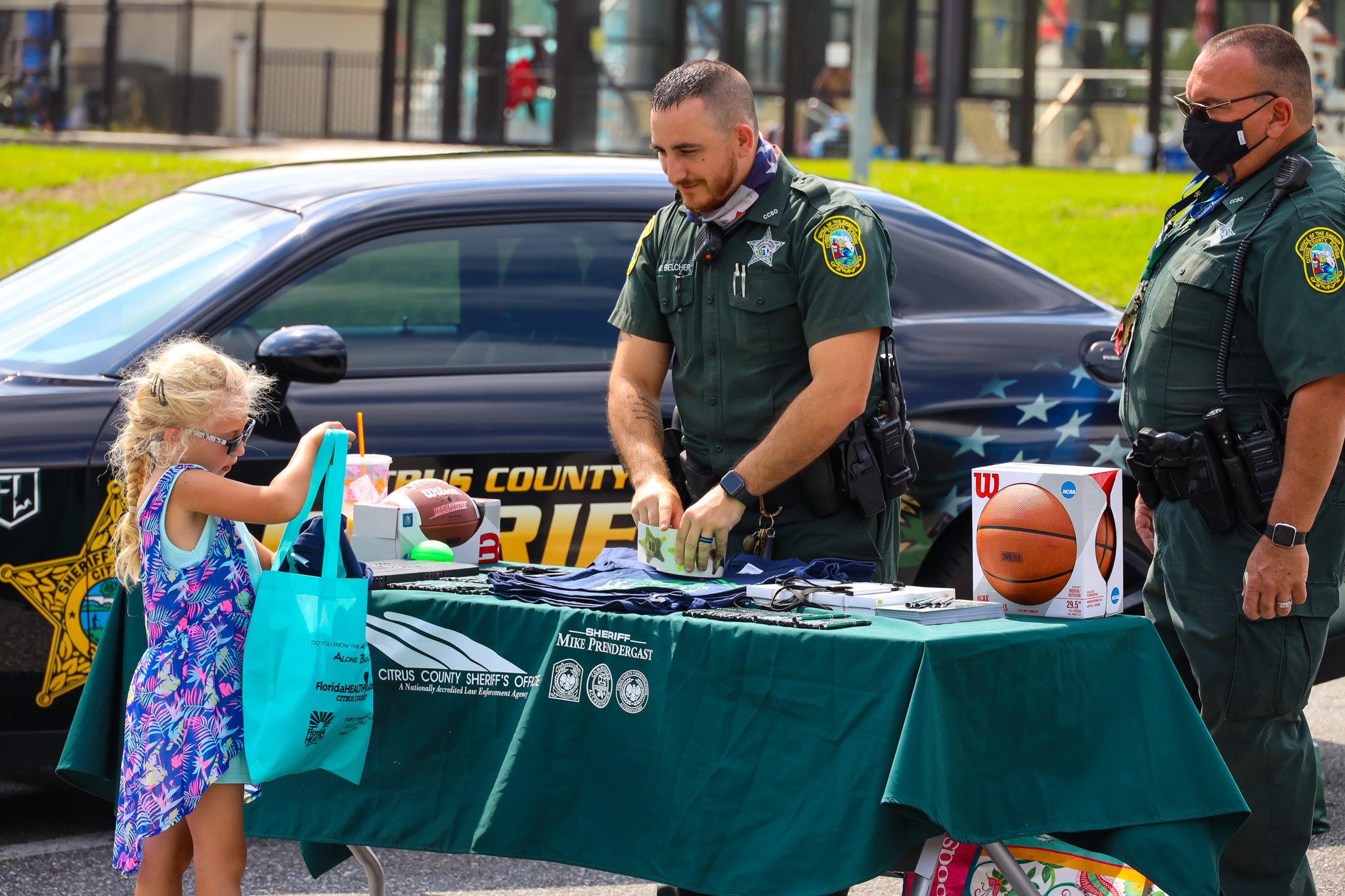 Sheriffs giving gifts to a child