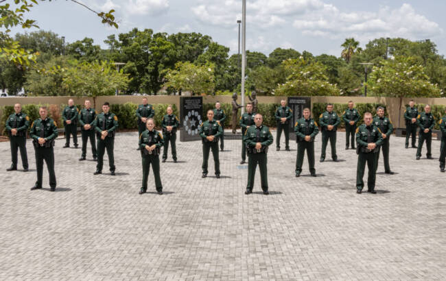 Sheriffs standing at memorial