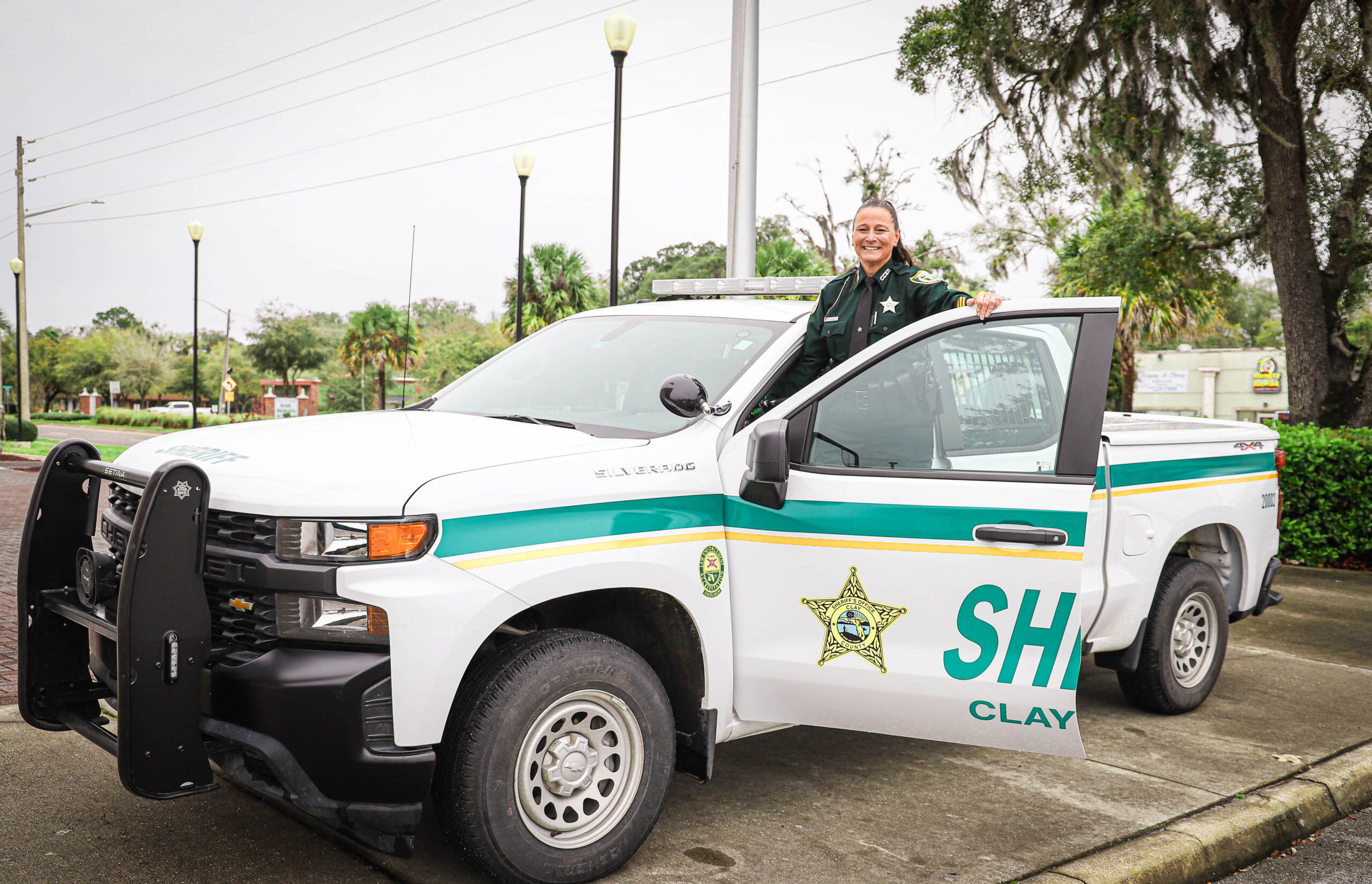 Sheriff smiling next to truck