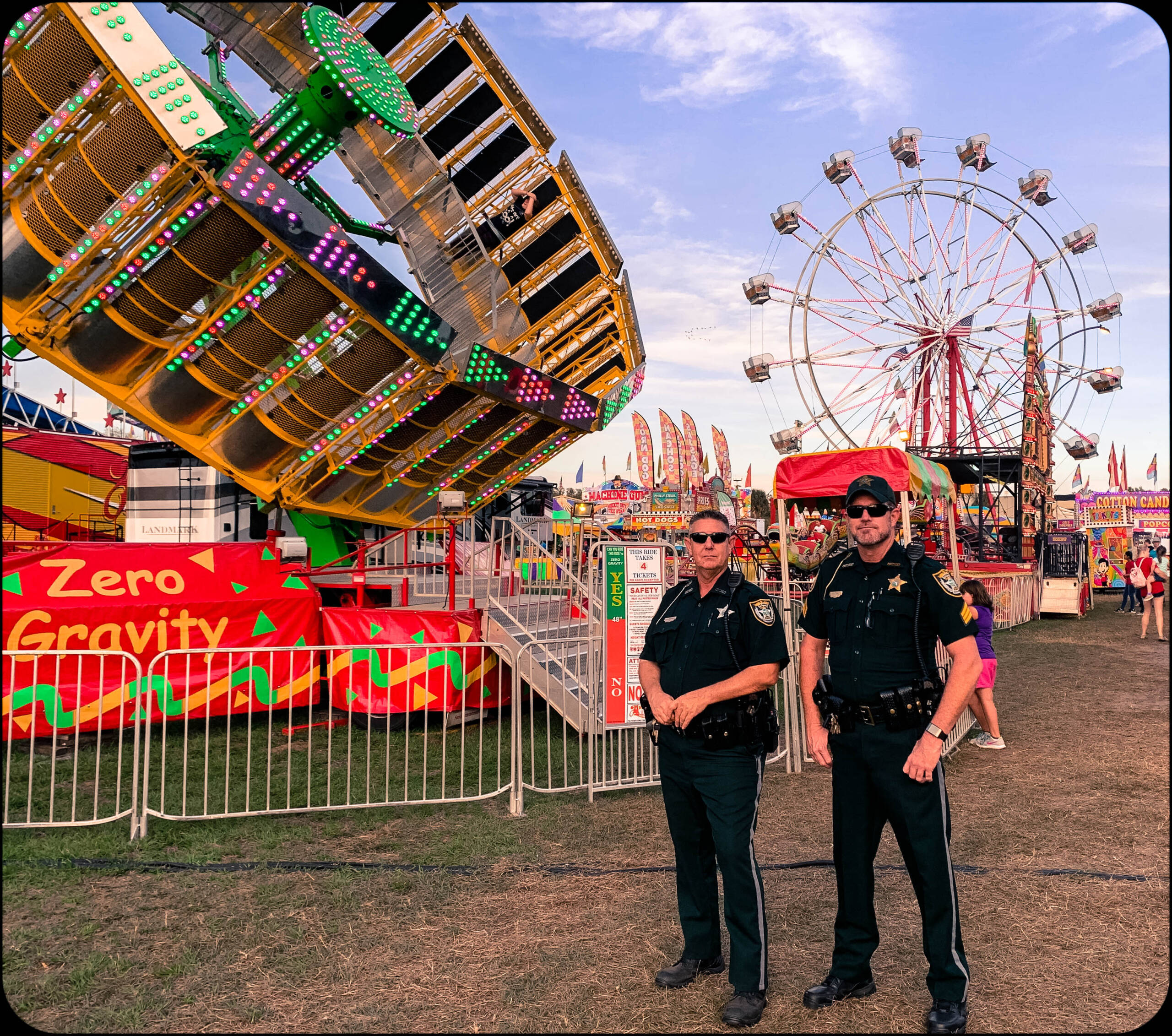 Sheriffs in front of a county fair ride