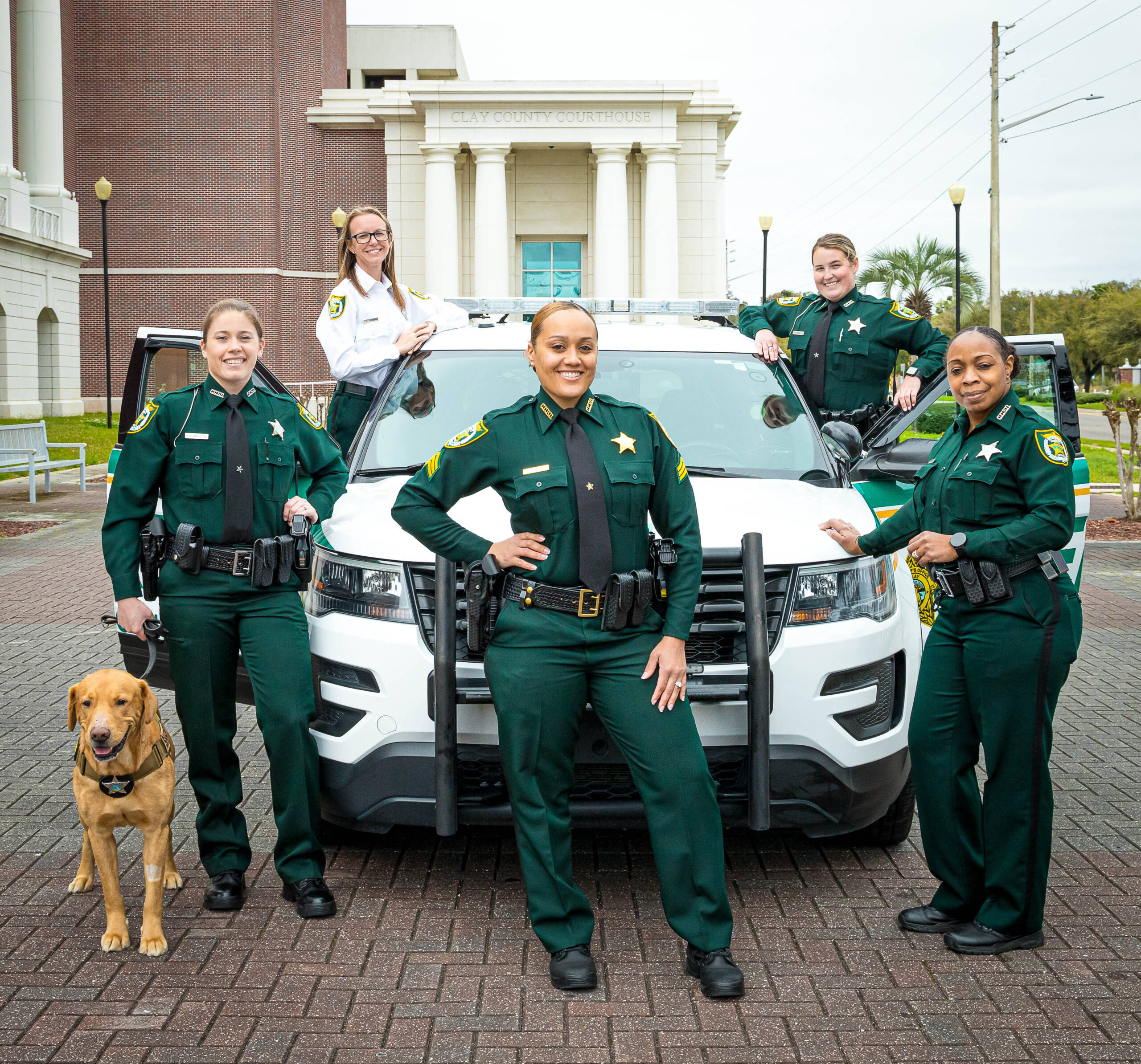 Lady sheriffs and k9 in front of SUV