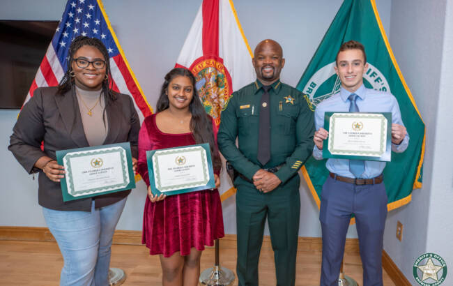 Three scholarship recipients with students